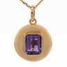 A gold pendant necklace featuring a round bezel-set emerald-cut purple gemstone, suspended from a delicate gold chain against a plain white background.